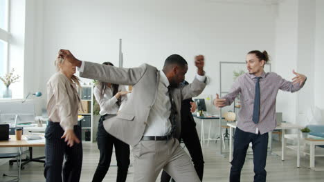 happy business team dancing in office