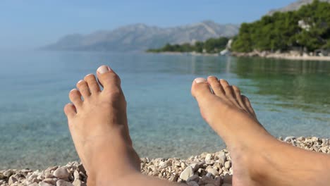 Bare-feet-on-the-beach-with-sea-view,-perfect-vacation-moment