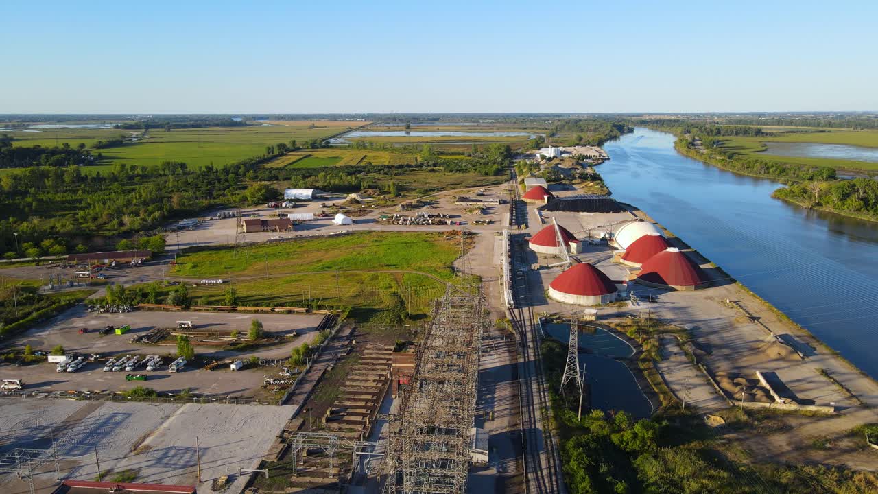 Freighter dock in Saginaw River on sunny evening, aerial view
