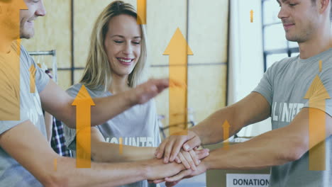 animation of yellow arrows over happy caucasian volunteer group stacking hands