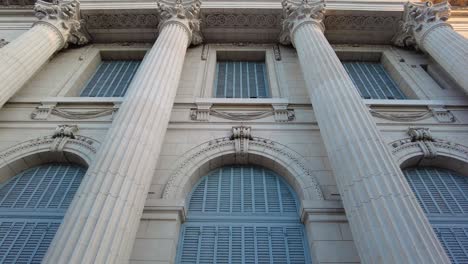 French-style-palace-museum-in-Buenos-Aires,-panining-through-the-facade,-seeing-the-details-in-the-greco-roman-columns-and-the-windows-of-the-piano-nobile