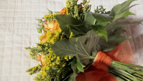 picking and leaving a flower bouquet from a white bed sheet