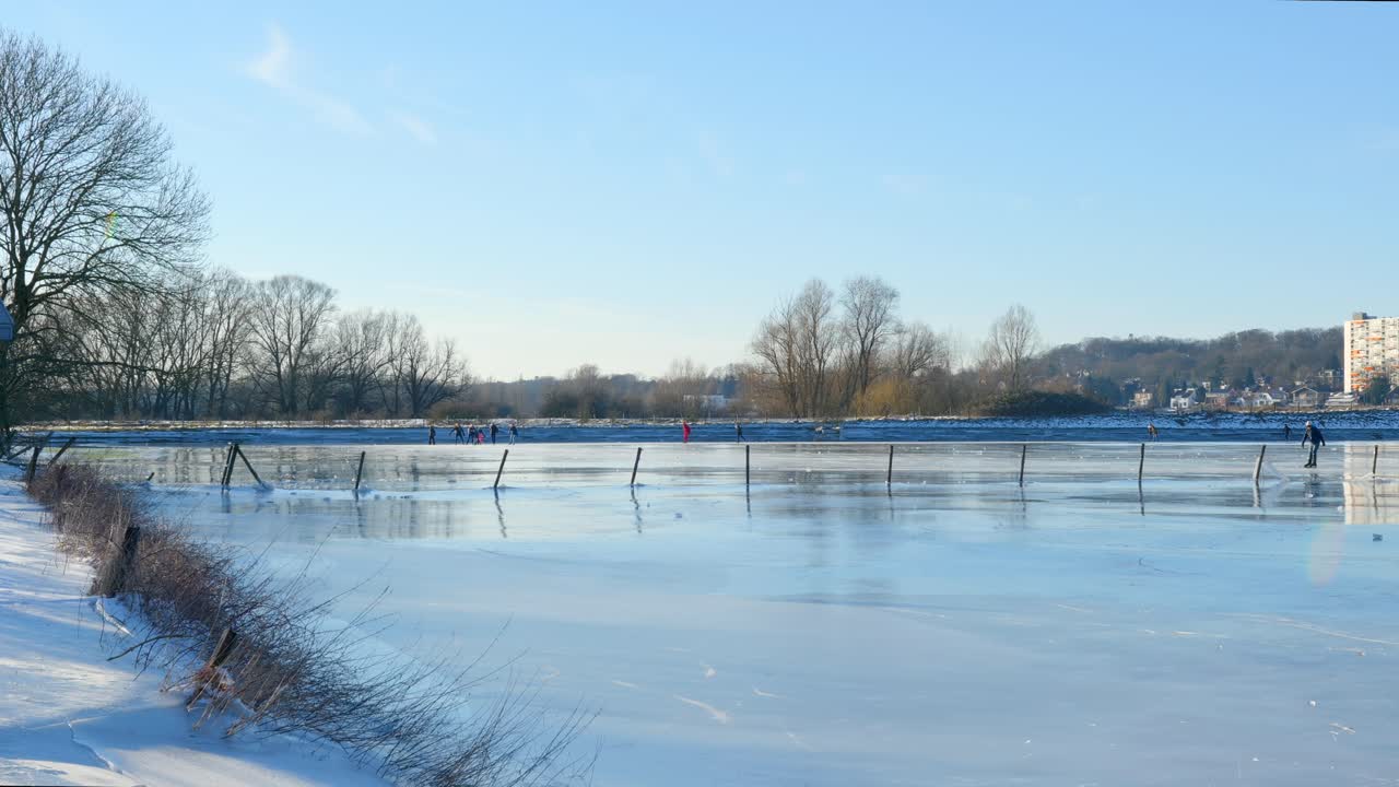 People ice skating on frozen lake in beautiful sunny weather (3)