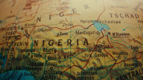 close-up of a vintage world globe, highlighting the location of nigeria.