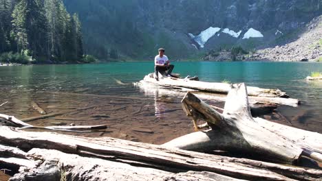 A-man-operating-a-drone-over-the-tranquil-Lake-Twentytwo-in-Washington