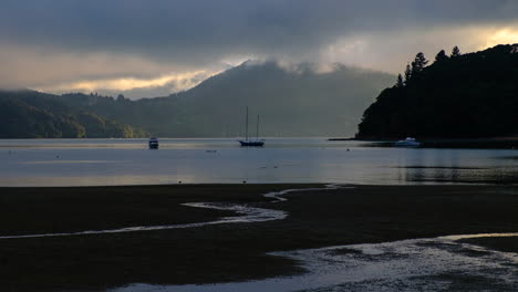 sunrise in calm bay in new zealand's south island