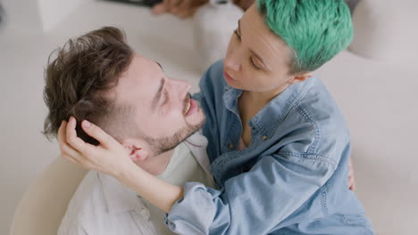 Top-View-Of-Young-Couple-Talking-And-Hugging,-The-Guy-Holds-The-Girl-Sitting-On-A-Chair