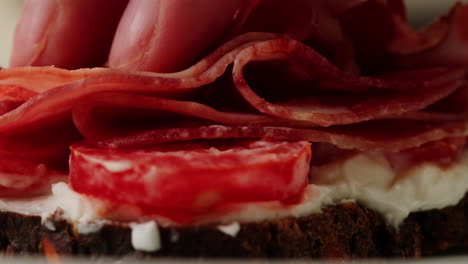 close-up of a sandwich with cured meats and cheese
