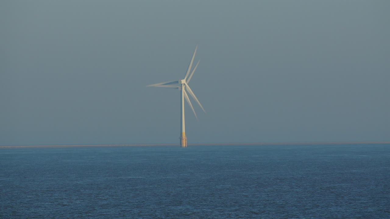Down the line shot of 2 Offshore wind turbines at Scroby Sands Wind Farm