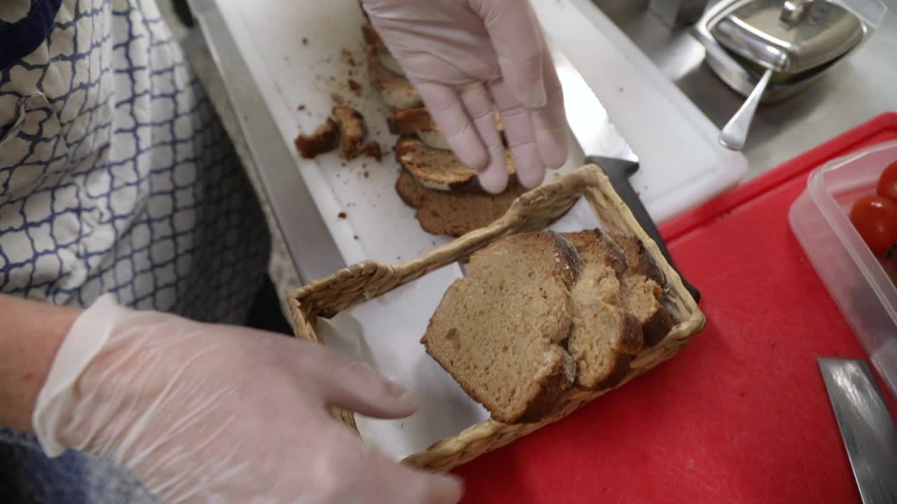 Slices Of Freshly Baked Bread Traditionally Served In A Small Bread Basket - high angle shot, slow motion