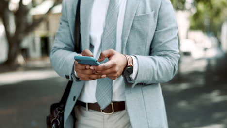 Business-man-hands-with-phone-in-city-street