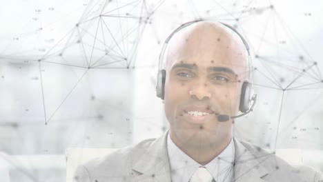 Animation-of-network-of-connections-over-businessman-with-headset-in-office