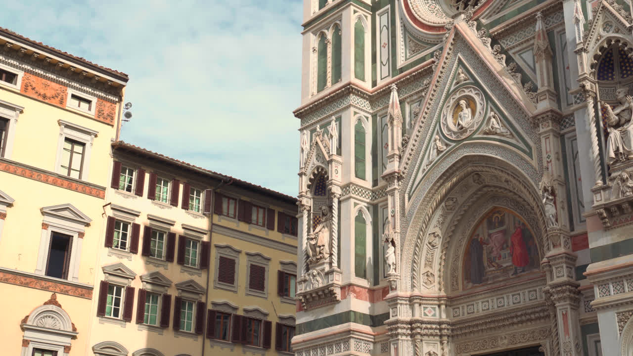 Wide of cathedral complex with tower and arches under warm light highlighting italian renaissance forms