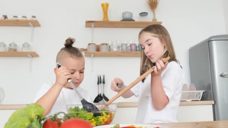 children prepare a fresh vegetable salad children prepare a fresh vegetable salad healthy food with vegetables and greens vegetarian children