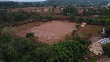 south brazil floods 2024 - drone shot of aftermath of floods in soccer court in sao sebastiao do cai city - rio grande do sul