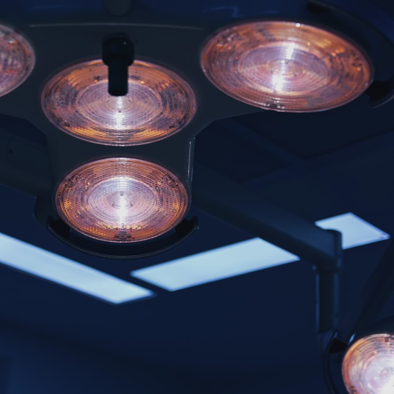 Medical lighting in the operating room. Lamp lights hanging on the ceiling in the hospital. Lighting equipment in surgical room. Close-up