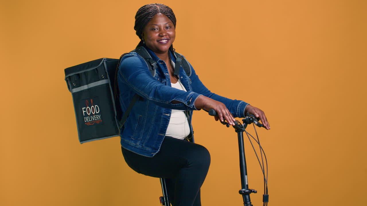 Woman Riding Bike With Bag On The Back