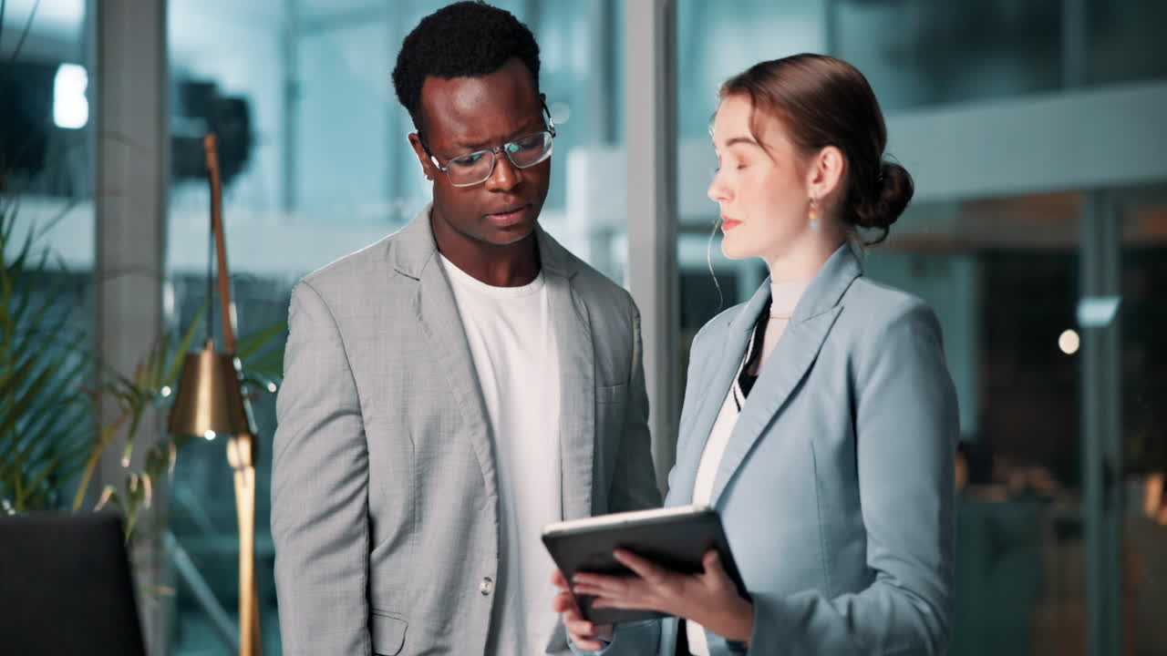 Business colleagues collaborating on a project with a tablet in the office