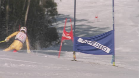 a skier races down a slalom course