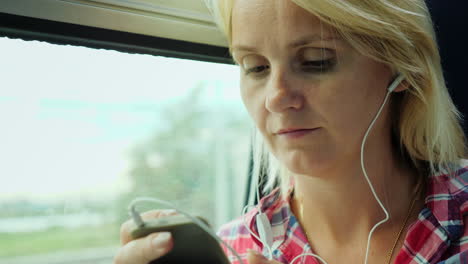 Woman-On-A-Train-Using-A-Smartphone