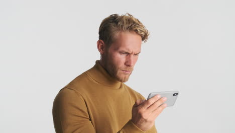 Serious-guy-watching-video-on-smartphone