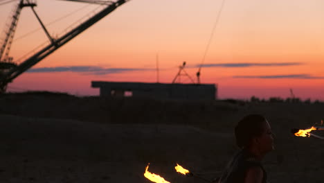 fire show artist breathe fire in the dark at abandon building slow motion. fire in heart shape.