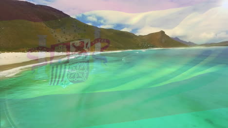 digital composition of spain flag waving against aerial view of waves in the sea