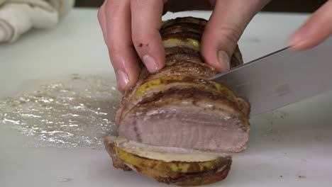 properly slicing a perfectly cooked pork roast with apples