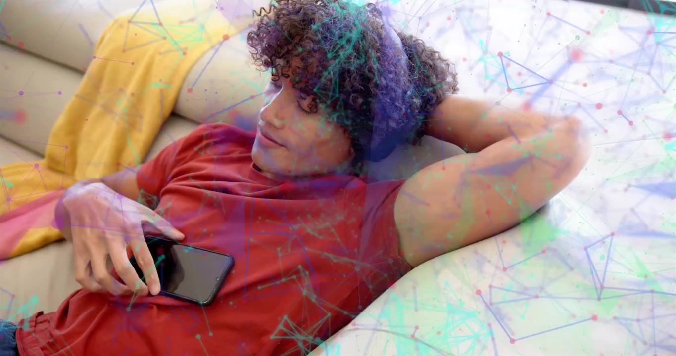 Man resting on sofa checking phone placing phone on chest while AR lines animating over scene