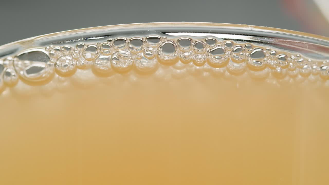 Orange or white wine bottle and glass, spanish french apple cider pouring, pouring of ecological natural wine.