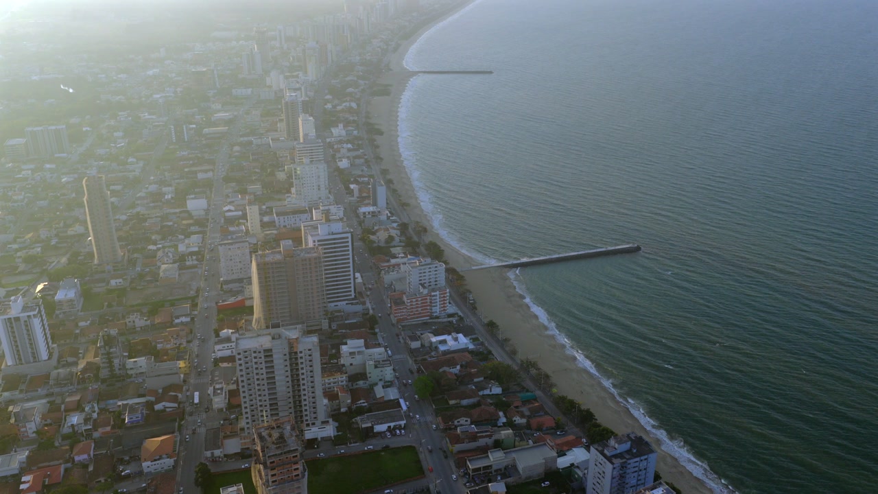 Aerial view of Balneário Piçarras, Santa Catarina, Brazil, showing coastal skyline, sandy beach, and calm Atlantic Ocean.