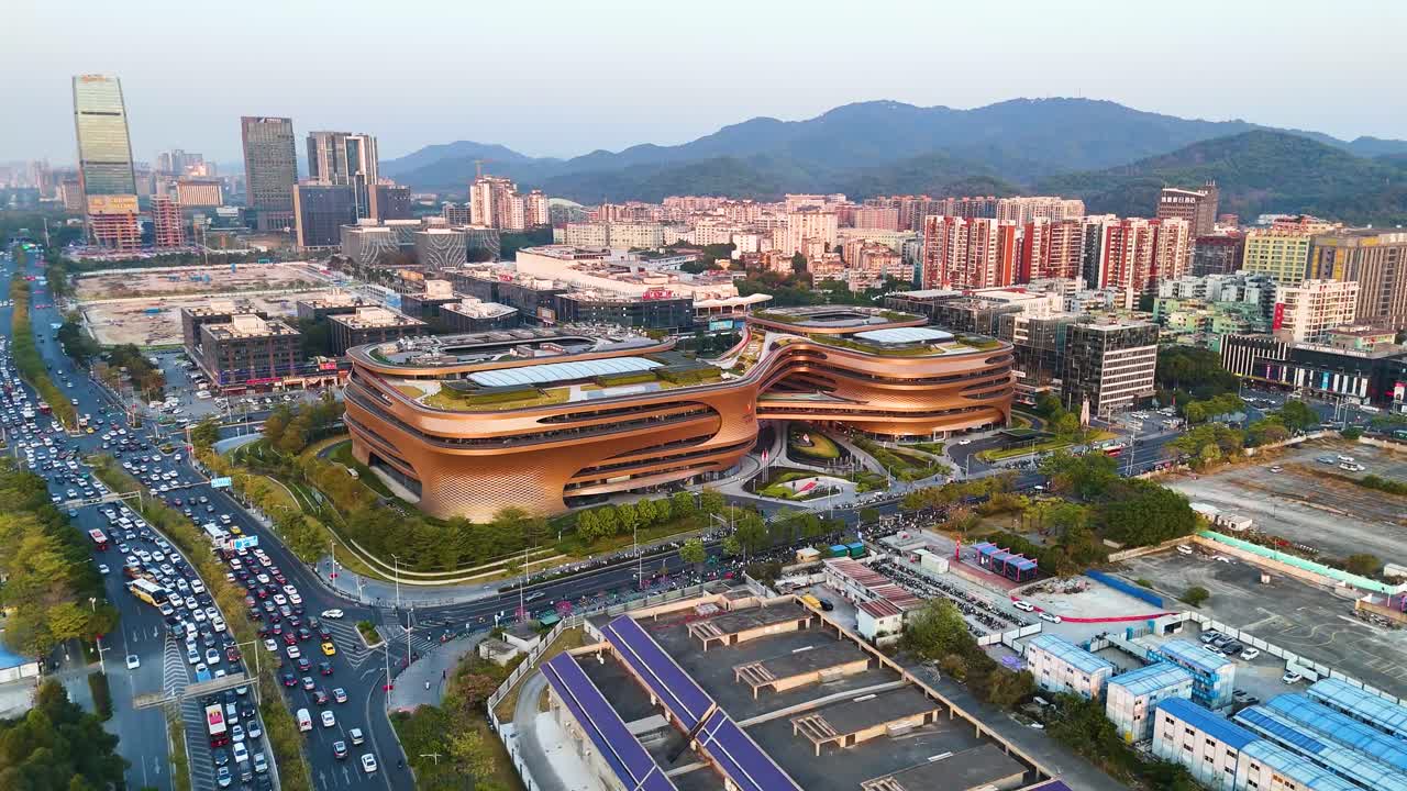 Drone shot of the futuristic Infinitus Building in Guangzhou, an innovative architectural design that combines corporate offices and a modern shopping mall. China.