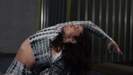 professional female acrobat and dancer from the circus stretching her muscles and warming up before a routine