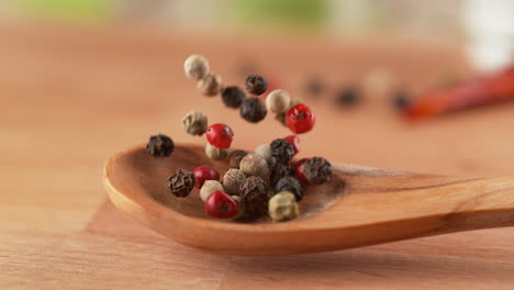 assorted peppercorns on wooden spoon