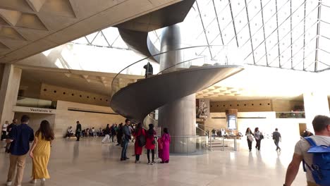 people walking inside louvre museum, paris