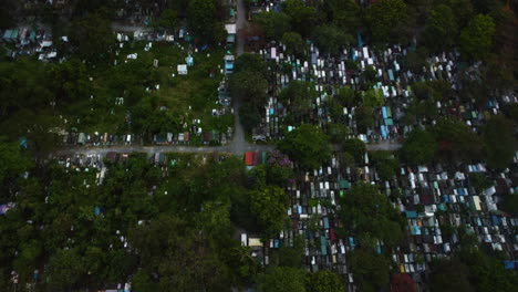 aerial view overlooking the manila south cemetery, in cloudy makati, philippines