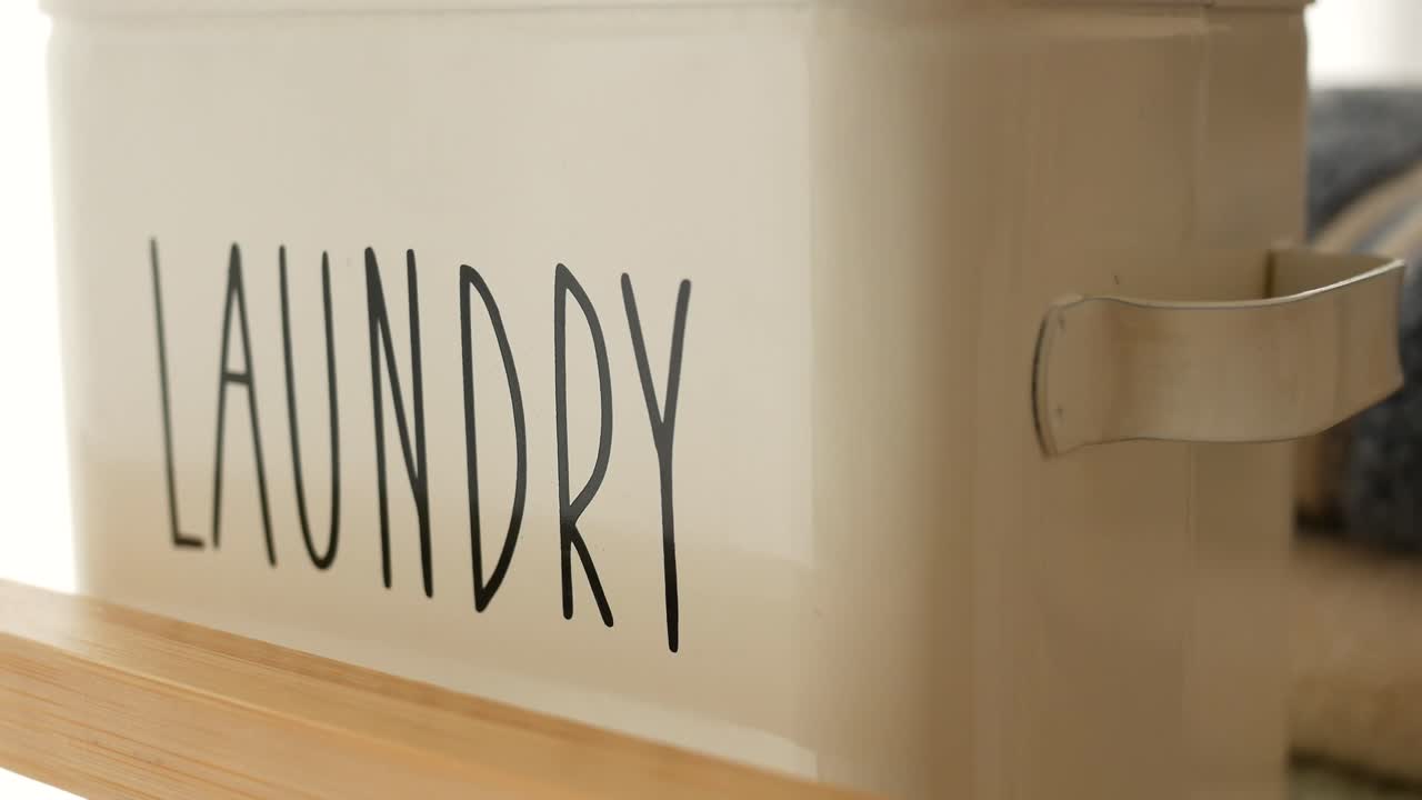Laundry storage container on a wooden shelf
