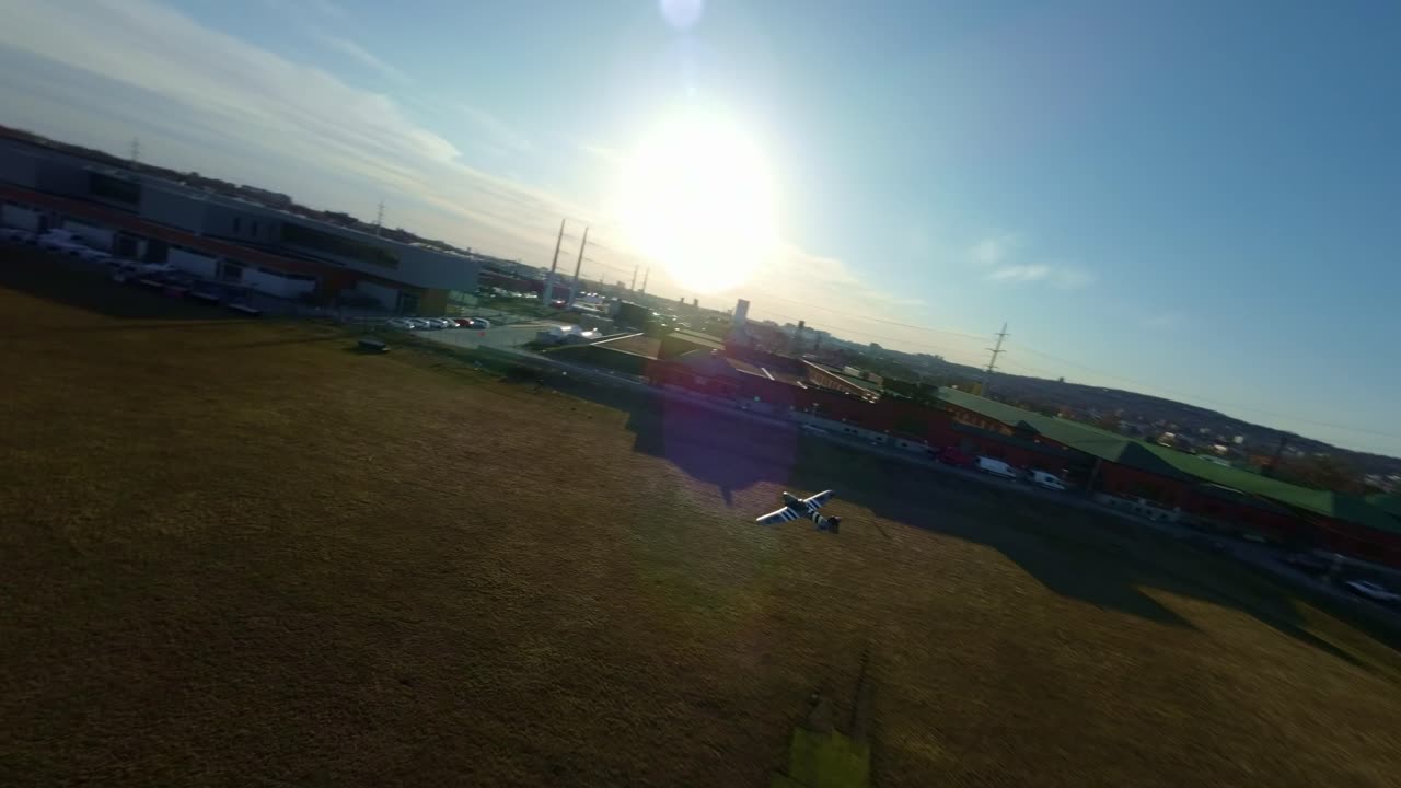 A Chase RC Plane Gliding High Above a Wide Field During Summer in Montreal, Canada - FPV Shot