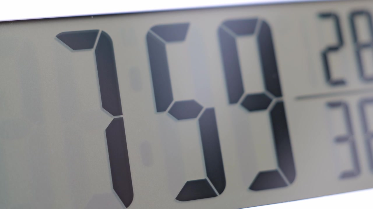 Close-up of a digital clock display highlighting precise timekeeping, modern technology, and everyday time management in a minimalist setting.
