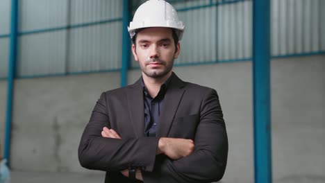 portrait confident factory manager wearing suit and safety helmet