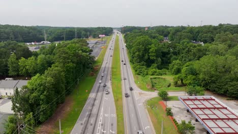 highway road traffic and movement towards riverdale, urban city green parks and surrounding, georgia, drone shot