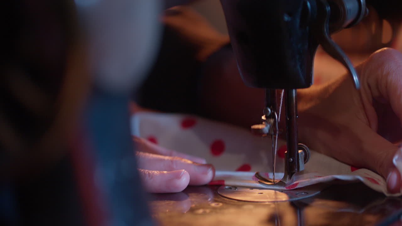 Close-up of Hands Sewing Fabric on a Vintage Sewing Machine