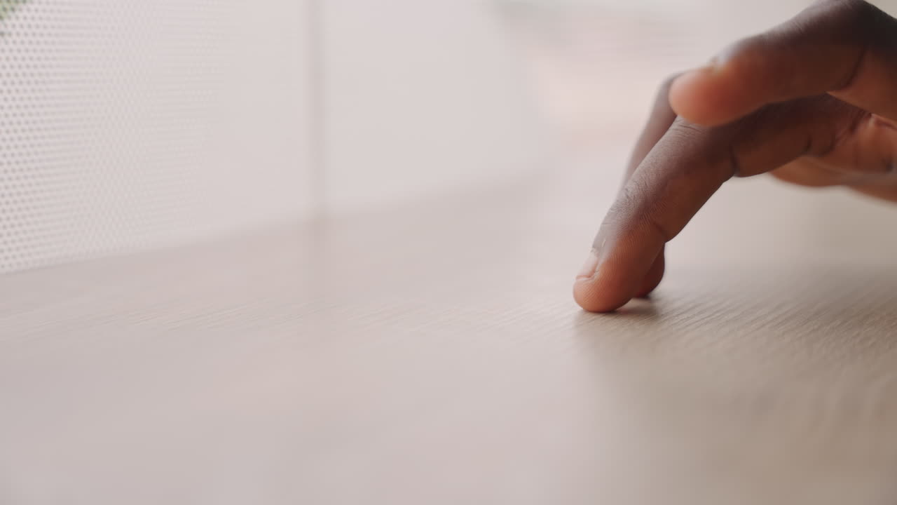 Intimate fingertip touch on wooden table, closeup of hand gently grazing surface near sheer curtain, subtle nervous energy before couples date, soft natural light and shallow depth of field create