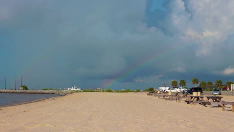 a rainbow arcs over a quaint beach