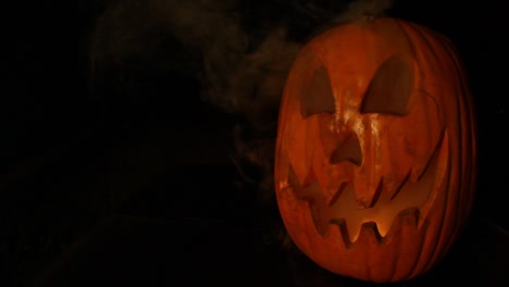 smoking tall jack o lantern with flickering pumpkin light halloween framed right wide angle lens