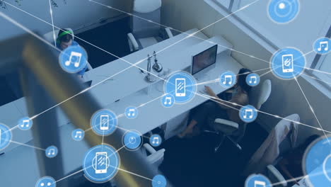 animation of network of connections with icons over diverse businesspeople in office