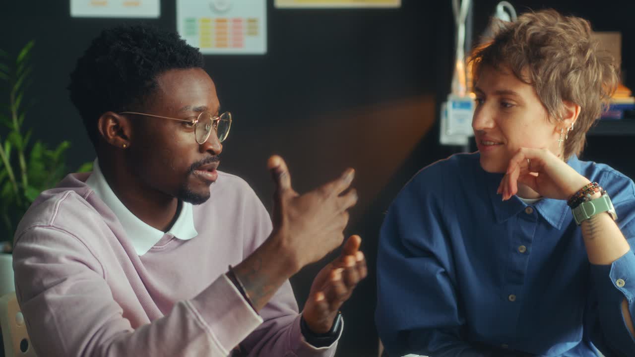 Two Diverse Coworkers Having Conversation during Office Day