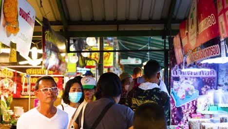 people browsing stalls at a bustling market