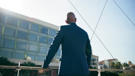 businessman contemplating on a bridge