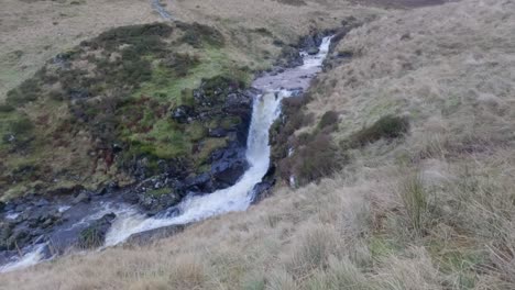 Panning-shot-of-the-water-running-down-a-small-waterfall-in-the-valley-of-the-Gray-Mares-Trail